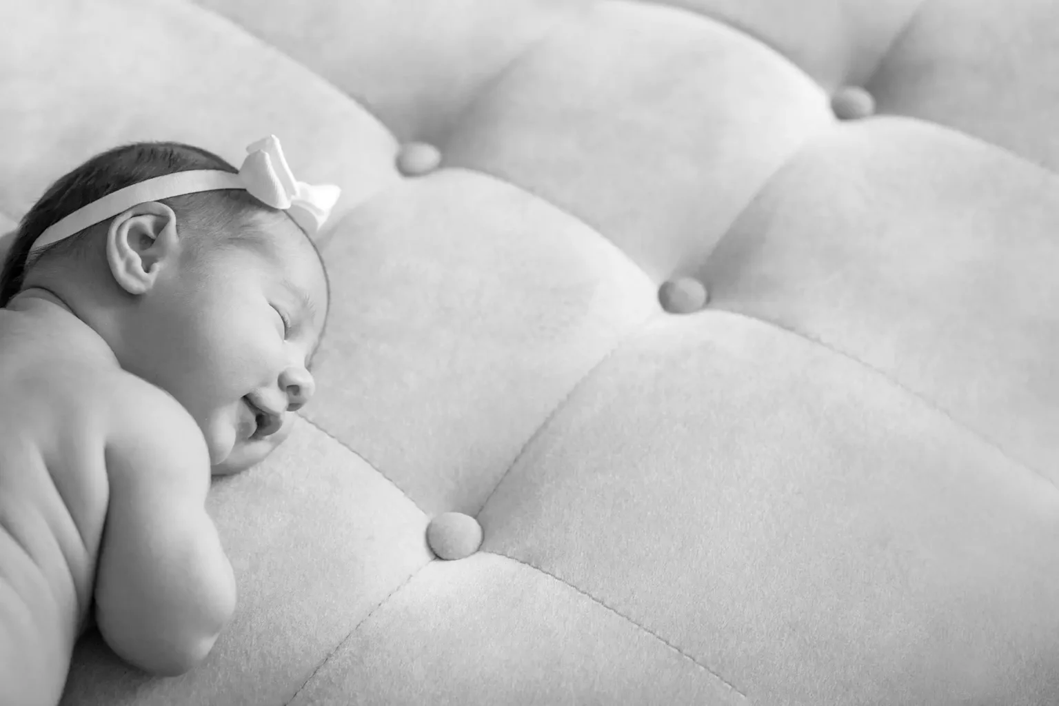 a baby sleeping on a couch