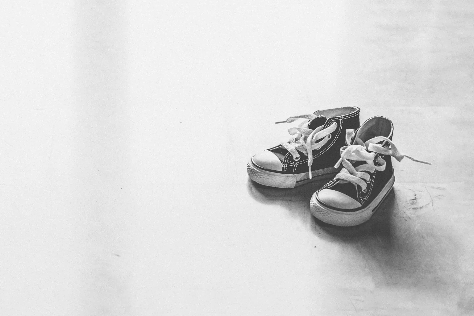 a pair of black and white sneakers