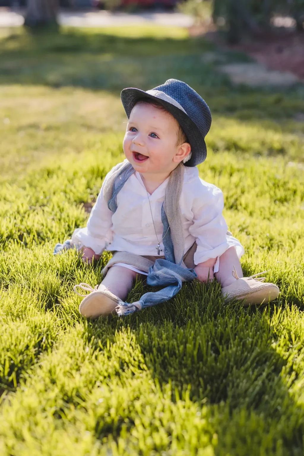 a baby sitting in the grass