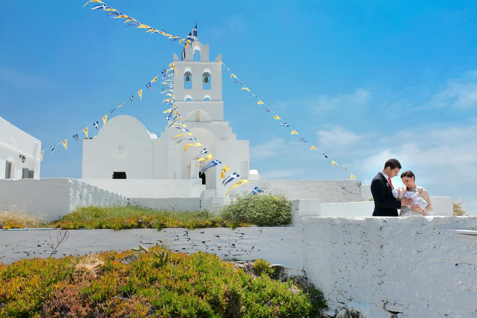 a man and woman standing on a wall with a building in the background