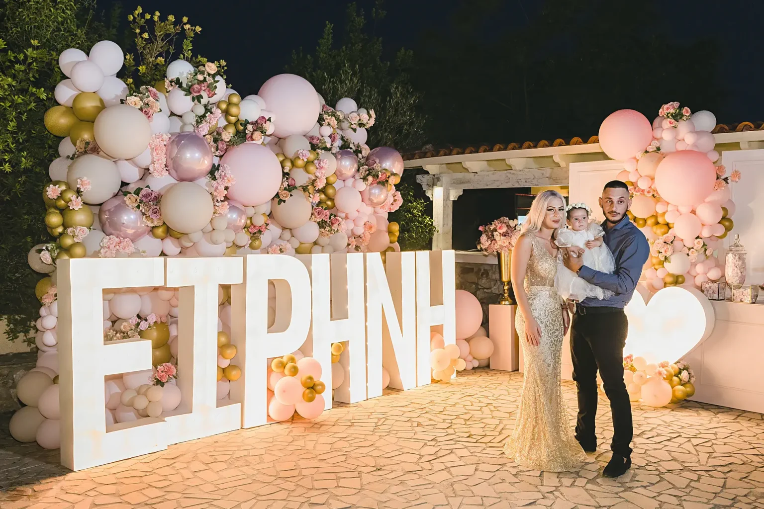 a man and woman holding a baby