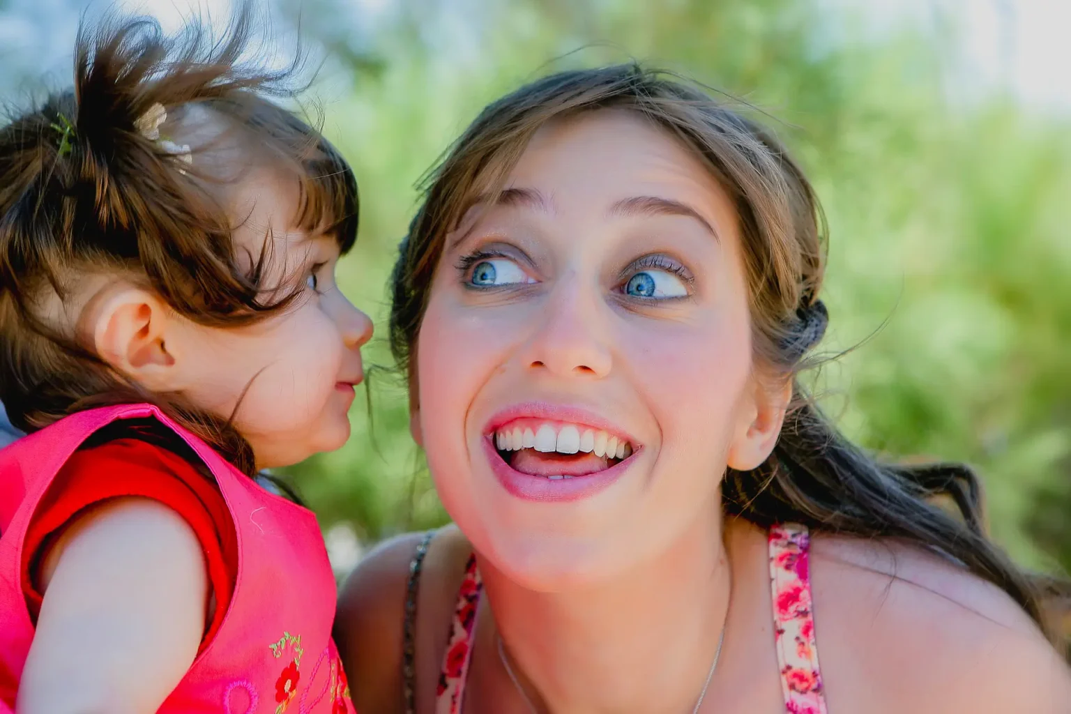 a woman and a child looking at each other