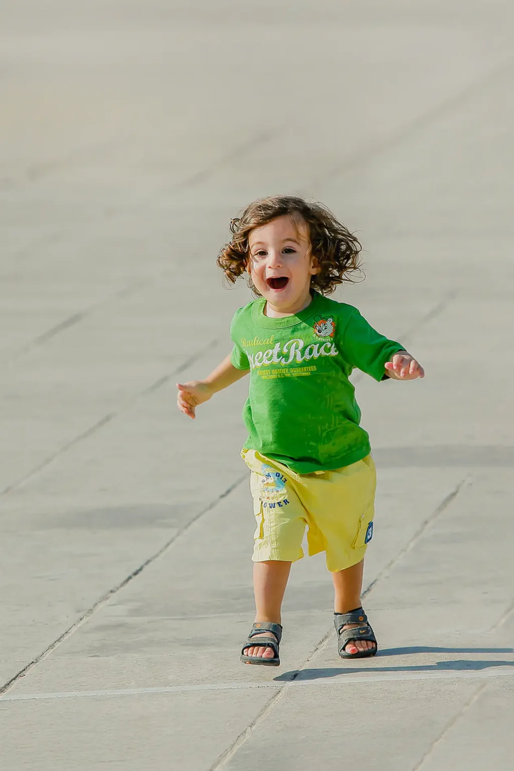 a child running on a concrete surface