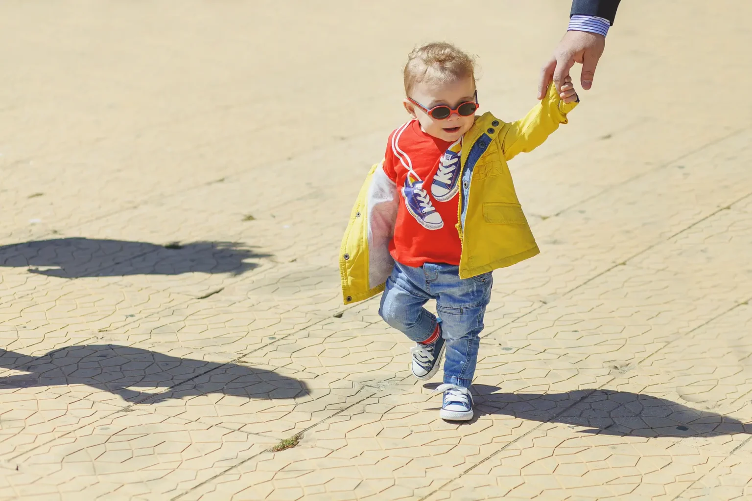 a child walking with a hand