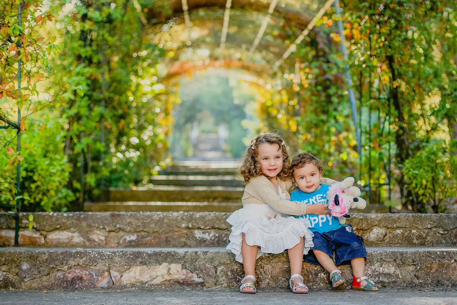 a two children sitting on stairs