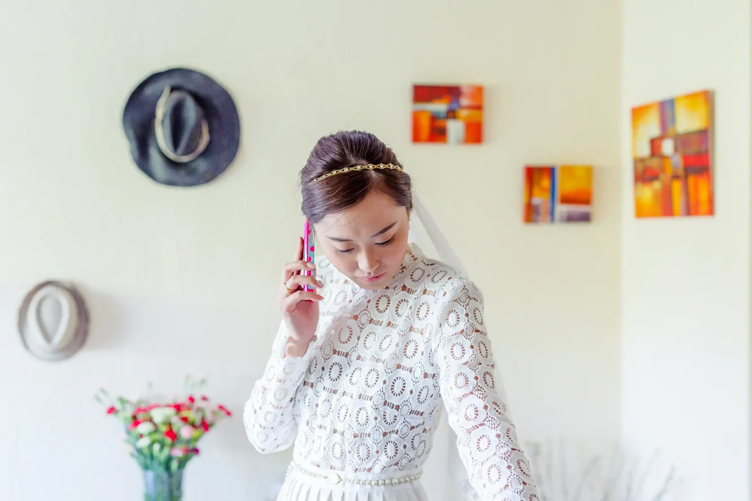 a woman in a white dress talking on a cell phone